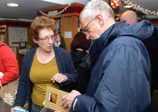 Residents in Cockermouth have pulled together after the floods. Here Jeremy Corbyn is pictured visiting a bookshop in the town.