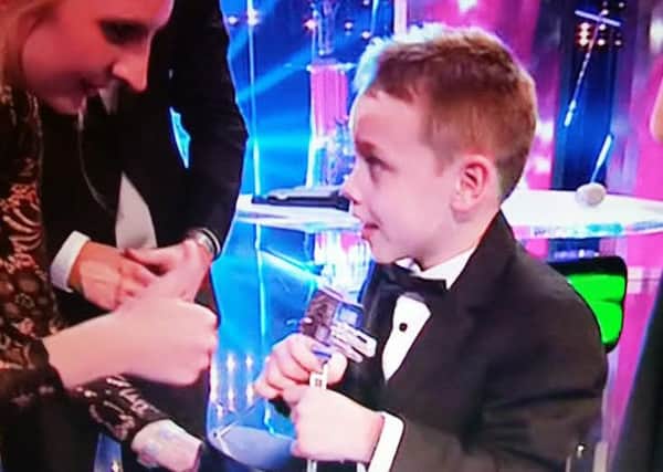 Bailey Matthews collects his Sports Personality of the Year award from Olympic swimmer Rebecca Adlington.