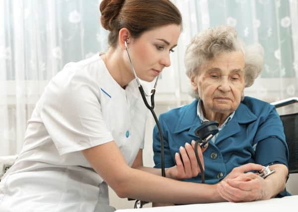 A nurse treats an elderly patient.