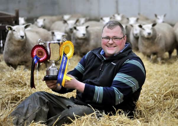 Paul Cass proudly holds his trophy from the York Auction Primestock sale.  Pic: Richard Ponter