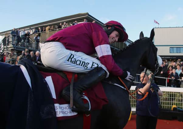 Bryan Cooper hugs Don Cossack after winning at Down Royal in October (Picture: Niall Carson/PA).
