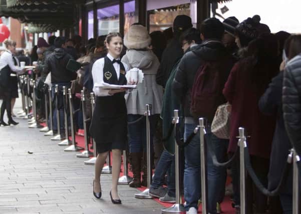 Shoppers queuing outside Harrods in Knightsbridge, London, for the start of last year's Boxing Day sales.