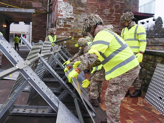 Soldiers from 2LANCS helping to set up flood defences in Appleby as the Army has been called in to support efforts to protect flood-hit areas of Cumbria amid fears that more heavy rain will fall.