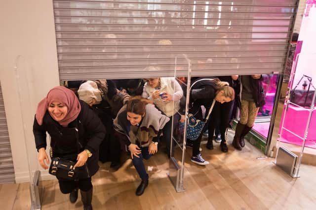 Shoppers rush to enter a River Island store at Brent Cross shopping centre in London as the Boxing Day sales get underway.