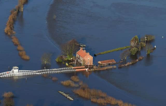 Floodwater surrounds houses in Cawood, North Yorkshire after the River Ouse burst its banks.  Joe Giddens/PA Wire