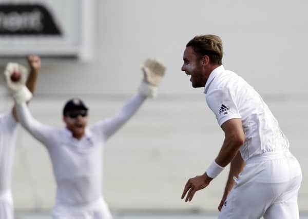 Englands bowler Stuart Broad, right, celebrates with team-mates.