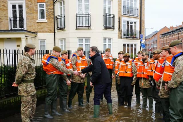 Prime Minister David Cameron greets soldiers working on flood relief in York city centre. Photo: Darren Staples/PA Wire