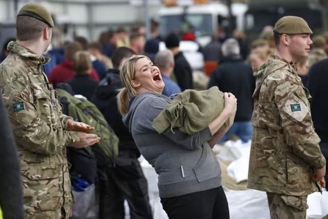 Soldiers and volunteers fill sand bags to assist with flood relief in York in North Yorlshire.  PRESS ASSOCIATION Photo. Picture date: Monday December 28, 2015. See PA story WEATHER Floods. Photo credit should read: Darren Staples/PA Wire