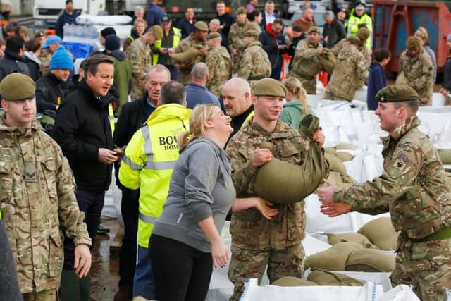 Prime Minister David Cameron talks to soldiers and volunteers filling sand bags to assist with flood relief in York in North Yorlshire.  PRESS ASSOCIATION Photo. Picture date: Monday December 28, 2015. See PA story WEATHER Floods. Photo credit should read: Darren Staples/PA Wire