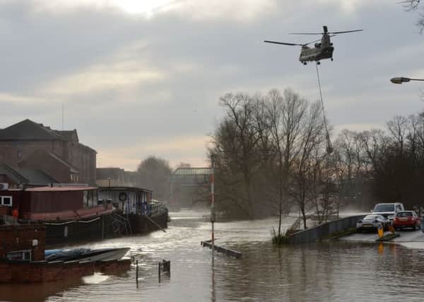 An army chinook helicopter airlifts equipment needed to repair the Foss Barrier on the River Foss in York following the weekend flooding.Picture: Anna Gowthorpe/PA Wire