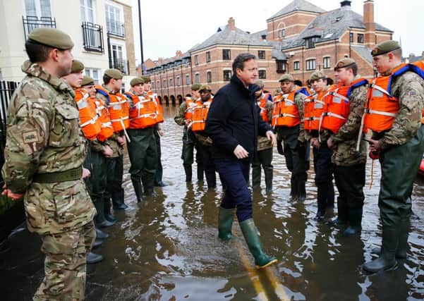 Prime Minister David Cameron greets soldiers working on flood relief in York city centre after the river Ouse burst its banks, in North Yorlshire.  PRESS ASSOCIATION Photo. Picture date: Monday December 28, 2015. See PA story WEATHER Floods. Photo credit should read: Darren Staples/PA Wire