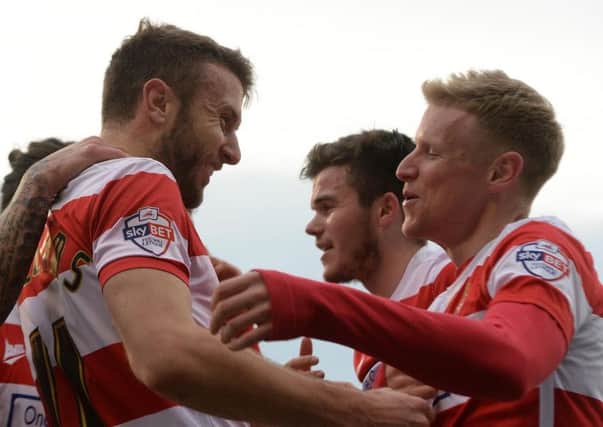 Team-mates celebrate with Andy Williams after he gave Rovers the lead at Oldham.