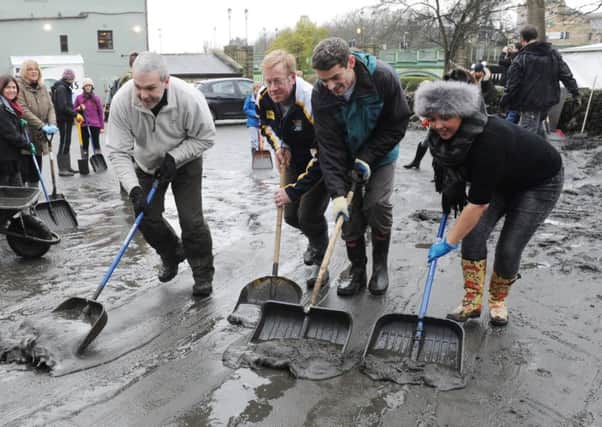 Volunteers clear the mud from the Kirkstall Bridge pub after the Boxing Day floods in Leeds. Pic: Steve Riding