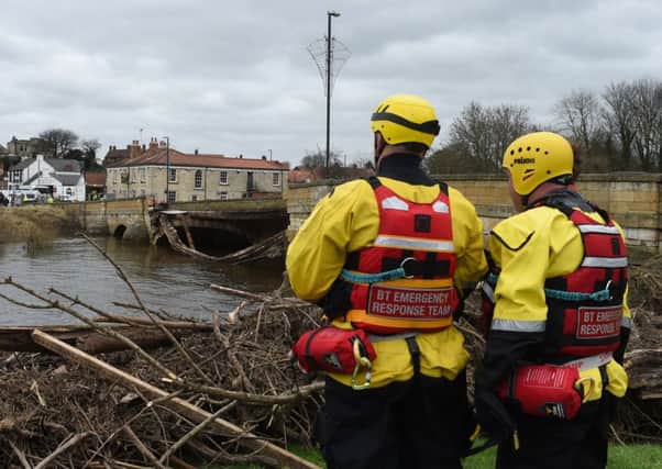 Emergency services by the bridge in Tadcaster, North Yorkshire, which has collapsed following recent flooding, as Storm Frank begins to batter the UK on its way towards flood-hit areas. PRESS ASSOCIATION Photo. Picture date: Wednesday December 30, 2015. The latest storm to sweep the country caused widespread disruption in Northern Ireland, with thousands of homes experiencing power cuts. See PA story WEATHER Floods. Photo credit should read: Joe Giddens/PA Wire