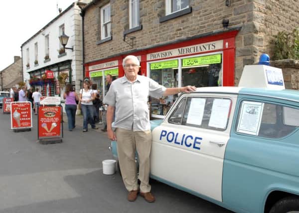 Heartbeat author Peter Walker, who writes under the name Nicholas Rhea, outside the Aidensfield Stores at Goathland, North Yorkshire.