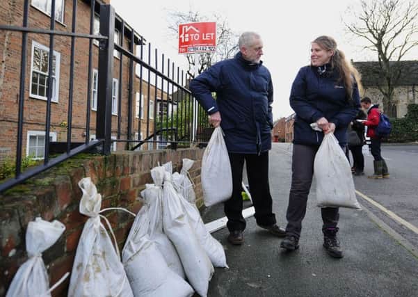 Labour leader Jeremy Corbyn and local Labour MP Rachael Maskell, lift some sandbags during his visit to view flood affected areas in York. (Picture: John Giles/PA Wire)