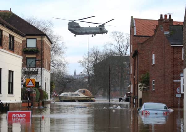 A Chinook helicopter delivers materials to repair to the flood defence systems in York
