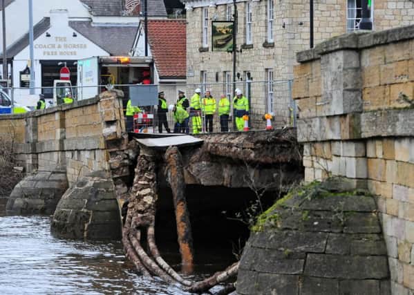 Police and Agency staff stand at the entrance to the historic Tadcaster Bridge which has partially collapsed.
Picture: Anthony Chappel-Ross