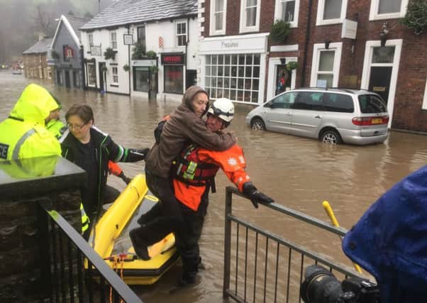 A stranded resident is rescued from the recent floods.