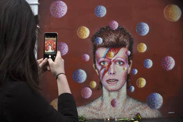 A mural of David Bowie on the wall of a Morley's store in Brixton, London, the singer's birthplace.