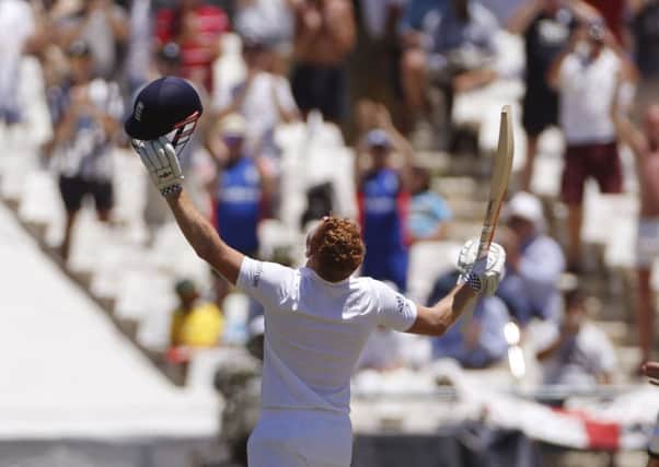 England's Jonny Bairstow, centre, reacts after making his century with Ben Stokes, left, during the second cricket Test against South Africa in Cape Town. (AP Photo/Schalk van Zuydam)
