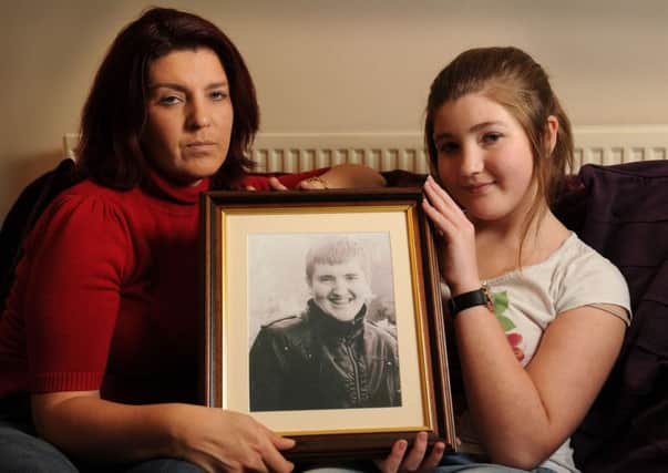 Karen Still and her daughter Rebecca hold a photo of their son and brother Jamie who was killed in an accident in Otley.