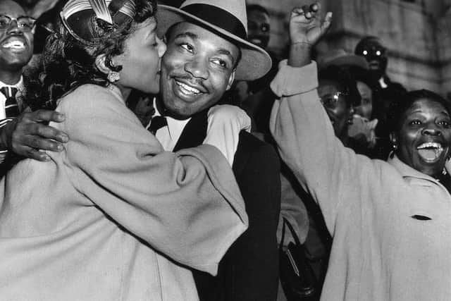 The Rev. Martin Luther King Jr. is welcomed with a kiss by his wife Coretta after leaving court in Alabama in March, 1956. (AP Photo/Gene Herrick).