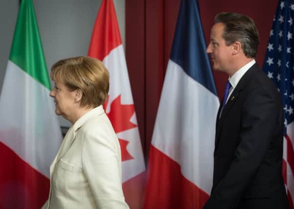 Is David Cameron following Angela Merkel's lead?