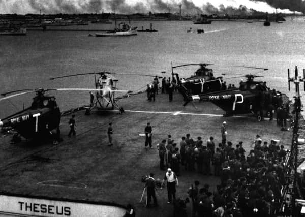 Soldiers and helicopters share the flight deck of a ship outside Port Said during the Suez Crisis in 1956. (PA).