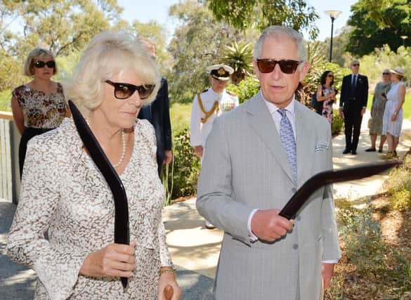 The Prince of Wales and Duchess of Cornwall holding elaborate Boomerangs given to them during a visit to Kings Park Perth in western Australia.