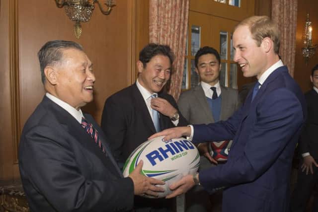 Former Japanese Prime Minister Yoshiro Mori presenting a large rugby ball to the Duke of Cambridge