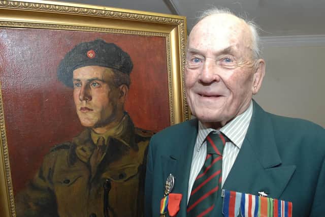 Decorated British Army veteran David Hopkins with a portrait of himself commissioned in 1946. (1512216AM3)