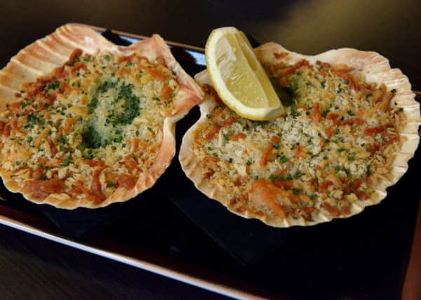 A starter of baked queenie scallops, garlic and parsley butter, cheddar & gruyere crust. PIC: Gary Longbottom