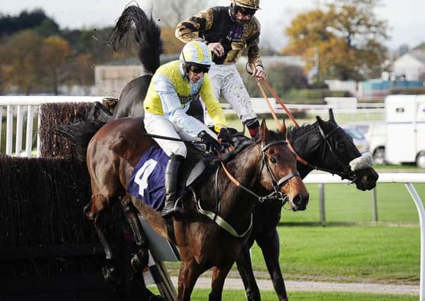 Jockey Sam Twiston-Davies (right), who finished second, is shot from the saddle on Fago as he challenges eventual winner Wakanda and Danny Cook at the final fence at Wetherby.