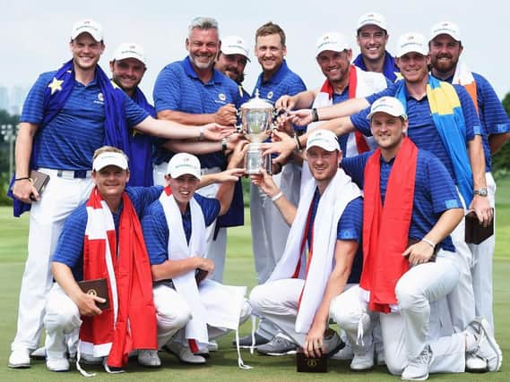 Sheffield's Danny Willett, standing, left, and Matt Fitzpatrick, front row second left, with their triumphant EuraAsia Cup team-mates and captain Darren Clarke (Picture: Getty Images).