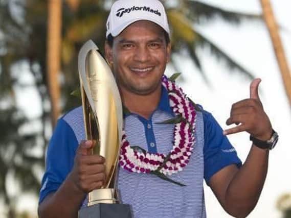 Argentina's Fabian Gomez fashions a Hawaiian 'shaka' sign as he holds the Sony Open trophy following his play-off victory (Marco Garcia/AP).