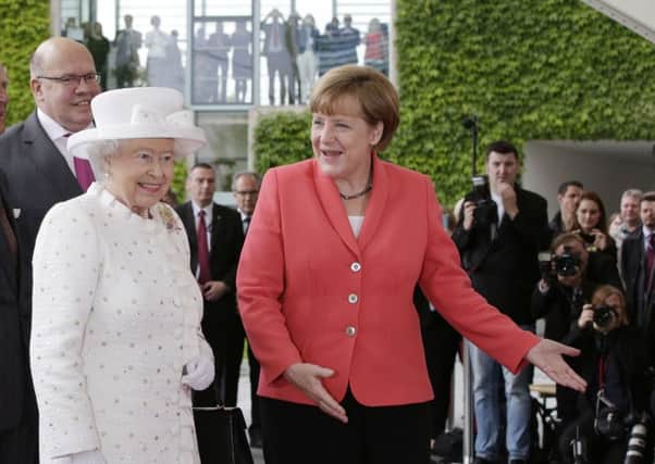 Angela Merkel, right, greets the Queen during last year's state visit to Germany.