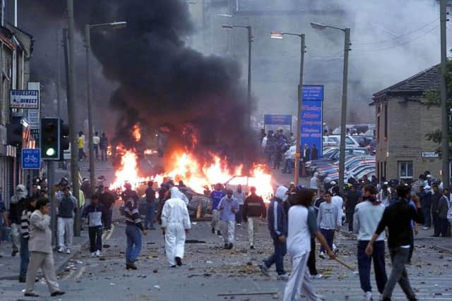 July 7 2001: A burning barricade on Abbey Street in Bradford as Asians and police clashed after a day of violence in the city.