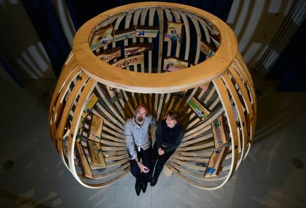 Sheffield-based wood craftsman Henk Littlewood and visual artist Mir Jansen  installing What you do; Where youre from; Who you know - a large wooden spherical sculpture lined with paintings referencing Ruskins ideas and thoughts at the Millennium Gallery in Sheffield. Picture: Scott Merrylees.