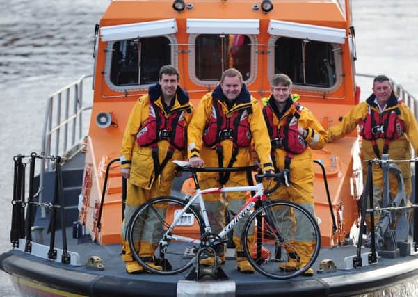Sir Gary Verity is pictured with the Whitby lifeboat crew; the RNLI will be the official charity of the 2015 Tour de Yorkshire.