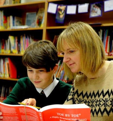 Luke Pearson, 11, a pupil at Lindley Junior School, George Street, Huddersfield, working with his teacher Mrs Tracy Durrans using the Toe By Toe reading material.