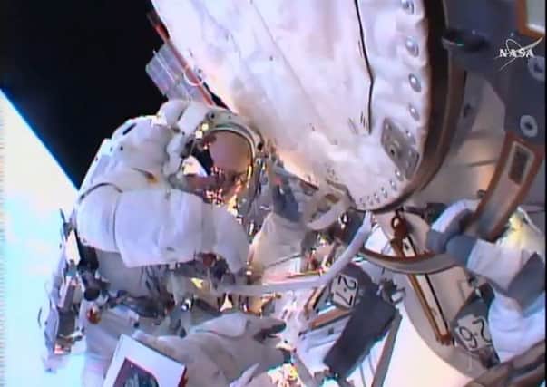 ESA astronaut Tim Peake seen on his first-ever spacewalk after having replaced a faulty voltage regulator on the International Space Station.  The image comes from his colleague spacewalker Tim Kopra's helmet-mounted camera.