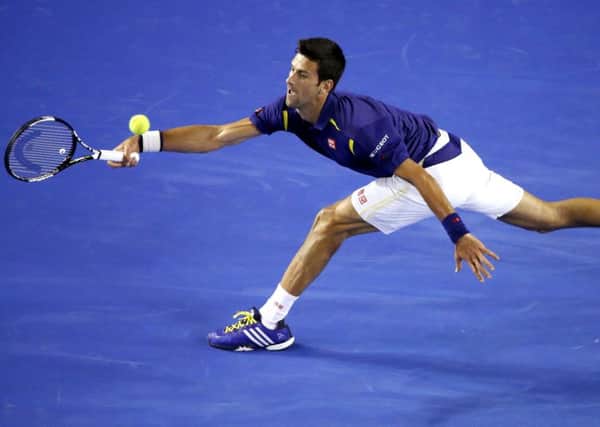 Novak Djokovic of Serbia hits a forehand return to Quentin Halys of France. (AP Photo/Vincent Thian)