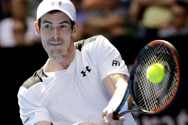Andy Murray of Britain makes a backhand return to Sam Groth in their second round match