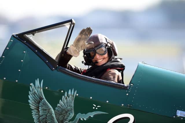 Tracey Curtis-Taylor waves to onlookers from the cockpit of her 1942 Boeing Stearman Spirit of Artemis biplane, before setting off from Farnborough Airport on her way to Sydney, Australia, to retrace the achievement of Amy Johnson.