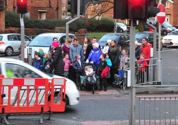 Families pictured earlier this month on the  pedestrian  island in the middle of Leeds Ring Road close to Highfield Primary School, Alwoodley.