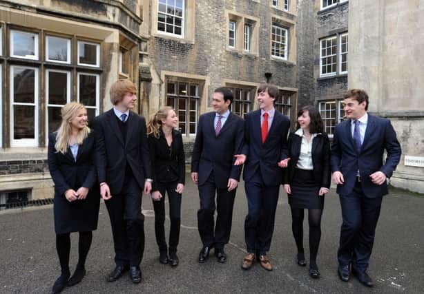 Head of St. Peter's School in York, Leo Winkley, centre, is pictured with students celebrating the school's success in GCSE exams in 2012.