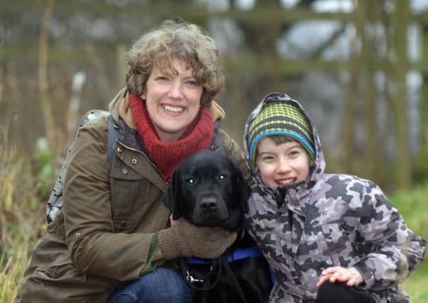 Farley the trainee autism assistance dog with Gregor, 11, and his mother Catherine