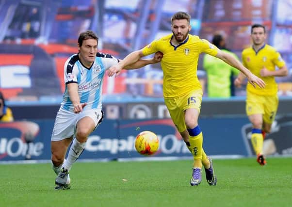 Leeds United's Stuart Dallas holds off Dean Whitehead, left, who is back for Huddersfield Town this week (Picture: Dean Whitehead)