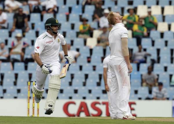 South Africas batsman Stephen Cook, left, runs to reach his century off Englands bowler Ben Stokes.